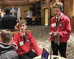 Eddie Zach in red jackets, doing an audio Interview 